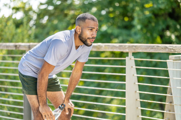istock African American exhausted man taking break from jogging 1409051637