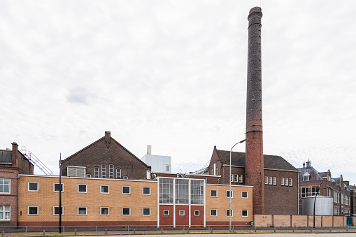 Industrial buildings of the old machine factory Stork with a high chimney on the Stork complex in Hengelo; the Netherlands.
