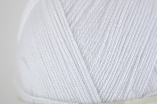 Hem seam made of white synthetic yarn
