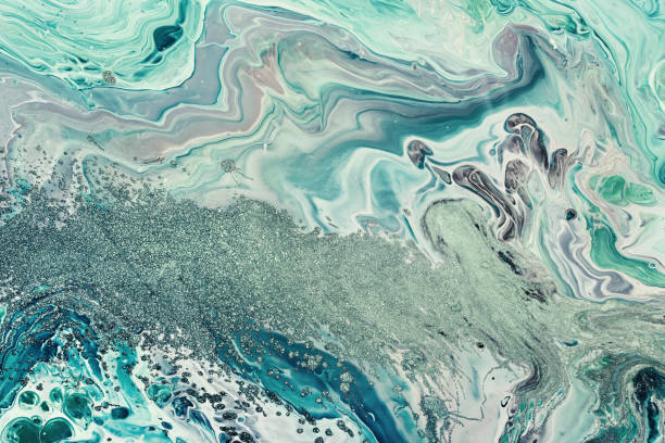 istock Fluid Art acrylic paints. Abstract mixing blue green waves. Liquid flows splashes. Marble effect background or texture 1409062976