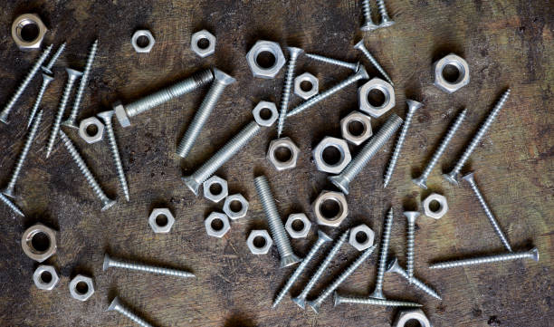 old nails screws and bolts on a background - fastening imagens e fotografias de stock