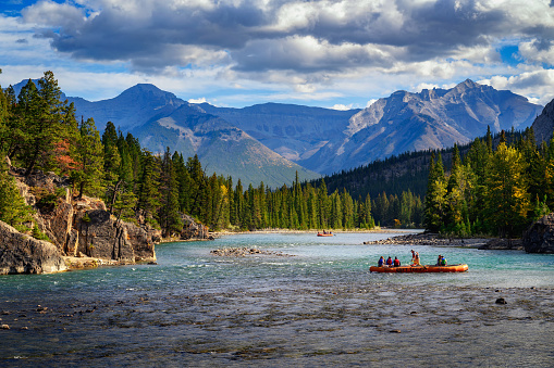 Banff, Alberta, Canada - September 26, 2021 : Tourists raft the Bow River in Banff National Park.