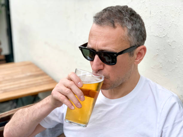 istock Middle aged man is drinking beer in a pub 1409066972