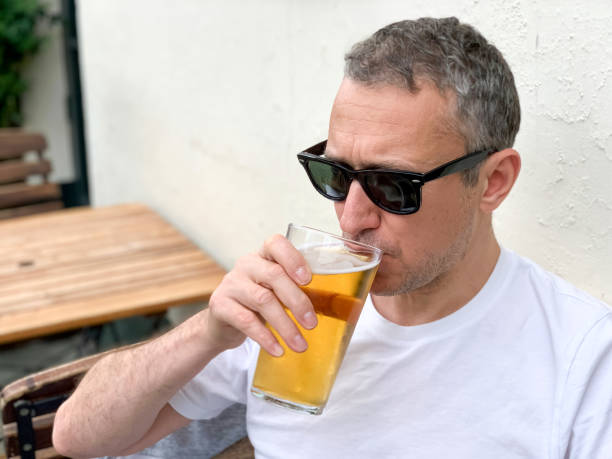 istock Middle aged man is drinking beer in a pub 1409067617