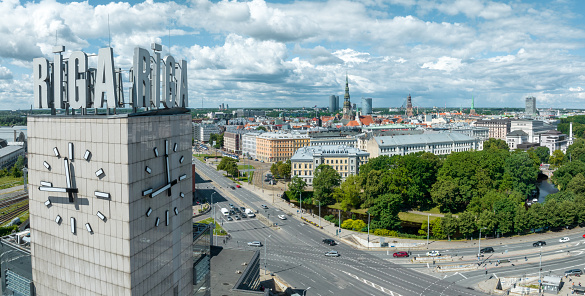 Riga, Latvia. July 10, 2022. Aerial view of the Riga central train station tower with name of the city and clock. Riga title on top of the tower.