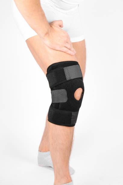istock Knee Support Brace on leg isolated on white background. Elastic orthopedic orthosis. Anatomic braces for knee fixation, injuries and pain. Protective knee joint bandage sleeve. Trauma, rehabilitation 1409071979