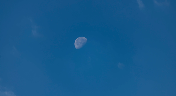 The  moon and clouds on the. blue sky.