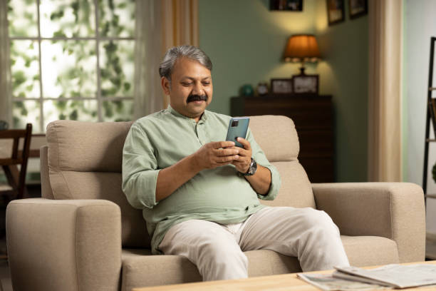 Portrait Of Man Sitting On Sofa stock photo stock photo