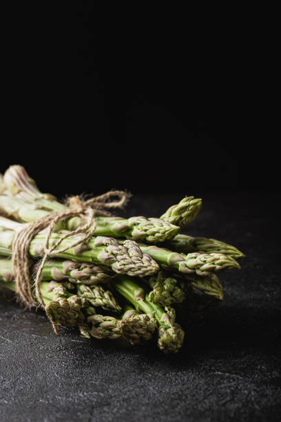 istock Green asparagus on a black background 1409074295
