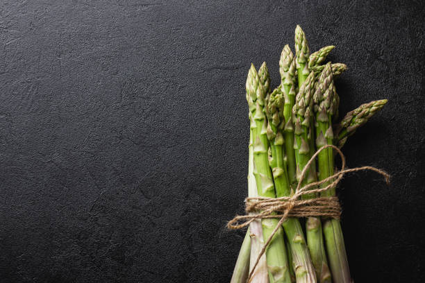 istock Green asparagus on a black background 1409074318