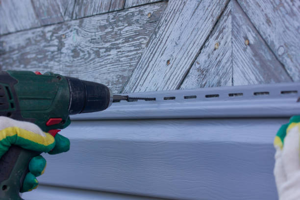 istock master twists siding on the wall with a screwdriver 1409075434