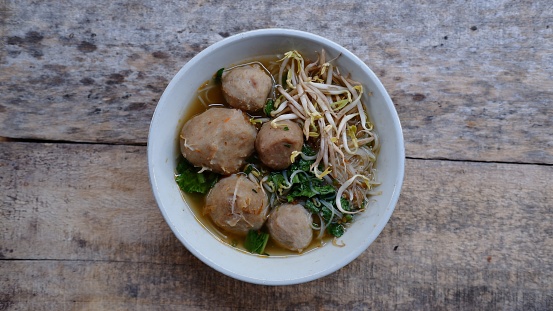 Bakso or Baso. Traditional Indonesian meatballs served with rice noodles Beans sprouts and green mustard. Indonesian street food called Bakso