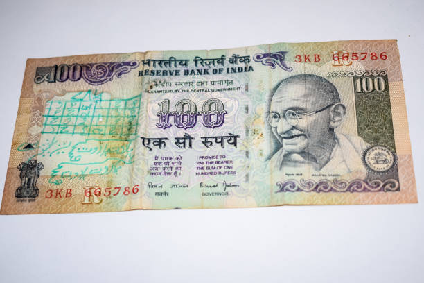 istock Rare Old One Hundred Rupee notes combined on the table, India money on the rotating table. Old Indian Currency notes on a rotating table, Indian Currency on the table 1409083252