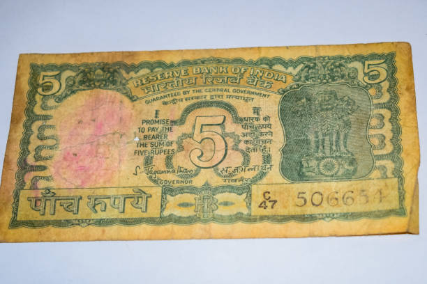 istock Rare Old Five Rupee notes combined on the table, India money on the rotating table. Old Indian Currency notes on a rotating table, Indian Currency on the table 1409083786