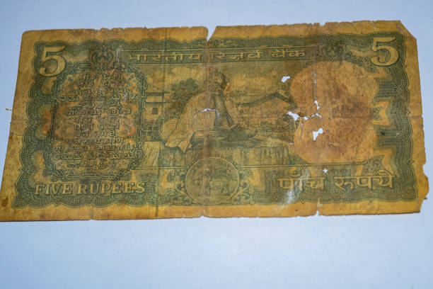 istock Rare Old Five Rupee notes combined on the table, India money on the rotating table. Old Indian Currency notes on a rotating table, Indian Currency on the table 1409083827