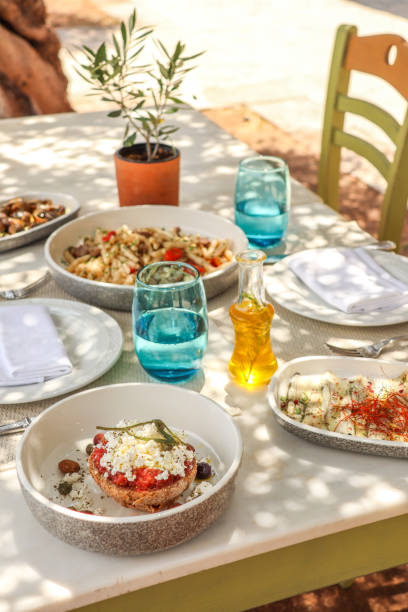 istock Greek Dinner Table with Food and Plates under olive trees with Cretan delicacies 1409084650