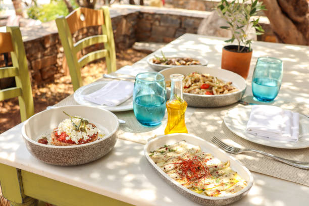 istock Greek Dinner Table with Food and Plates under olive trees with Cretan delicacies 1409084858