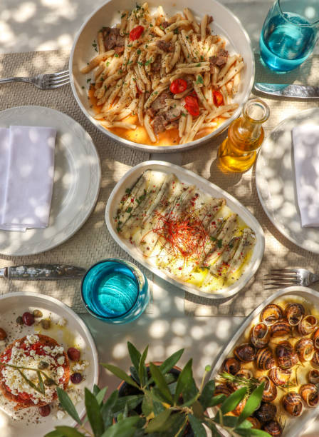istock Greek Dinner Table with Food and Plates under olive trees with Cretan delicacies 1409084973