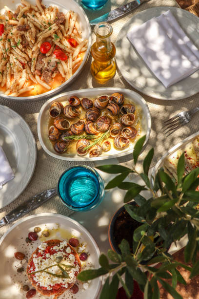 istock Greek Dinner Table with Food and Plates under olive trees with Cretan delicacies 1409084983