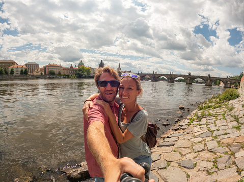 Travel couple exploring the city and the famous landmark. \nPrague, Czech Republic