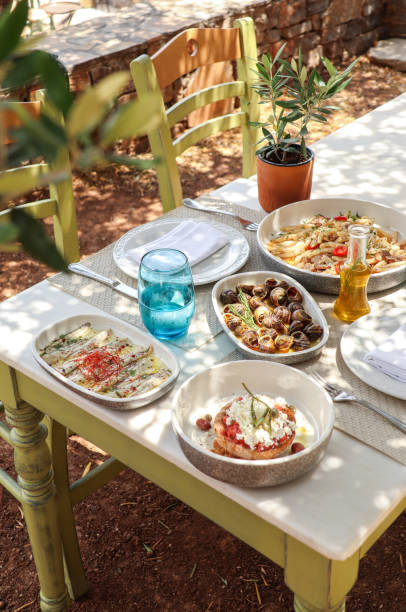 istock Greek Dinner Table with Food and Plates under olive trees with Cretan delicacies 1409086169