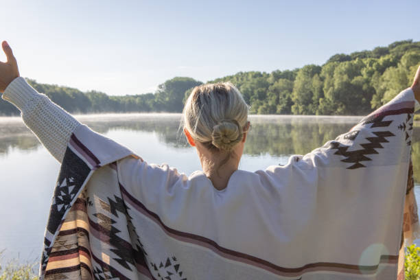 istock Woman arms up by the lake 1409086295