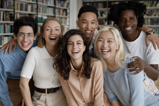 istock Happy multiethnic students posing look at camera standing in library 1409086682