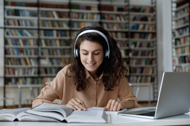 istock Student sit at table with textbooks, read topics, prepare essay 1409086744