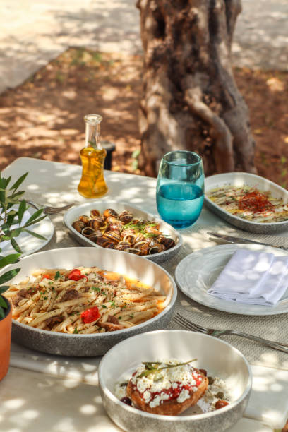 istock Greek Dinner Table with Food and Plates under olive trees with Cretan delicacies 1409086863