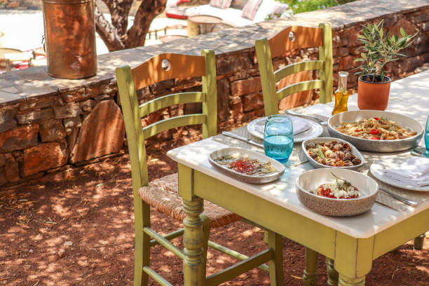 istock Greek Dinner Table with Food and Plates under olive trees with Cretan delicacies 1409087209