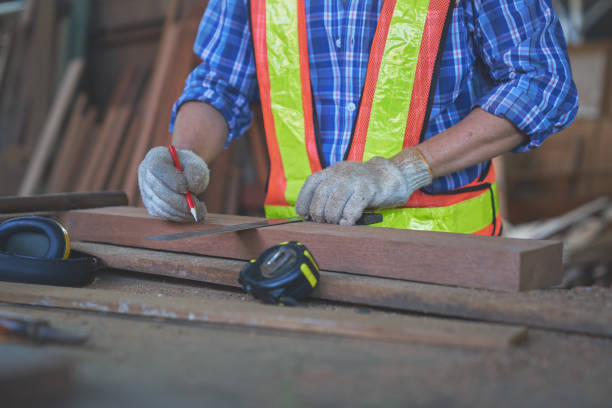 istock Asian old man carpenter work on metering wood before cutting for 1409088617