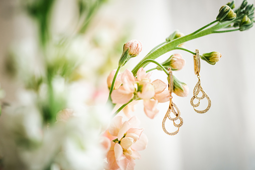 Luxury earrings and a bridal bouquet. Delicate and beautiful jewellery