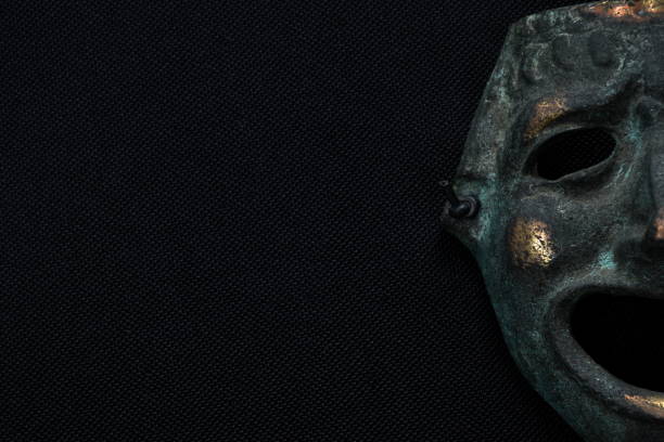 istock iron human face mask smiling on black fabric background 1409090446