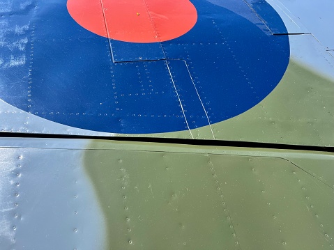 Exterior of a plane with riveted panel lines and a hatch handle.