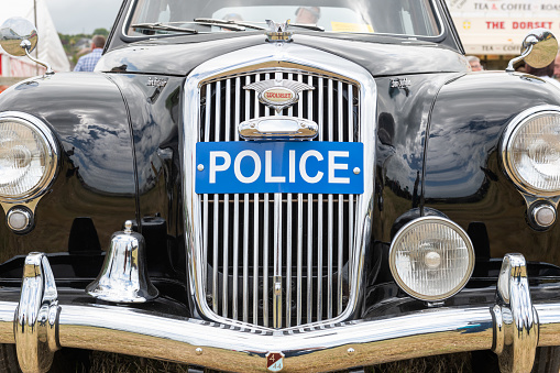 West Bay.Dorset.United Kingdom.June 12th 2022.A vintage Wolseley police car is on display at the West Bay vintage rally
