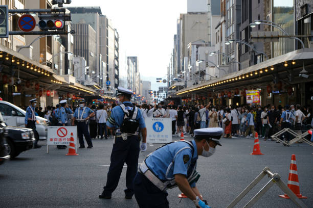 Police officers set up a pedestrian zone during the Gion Festival stock photo