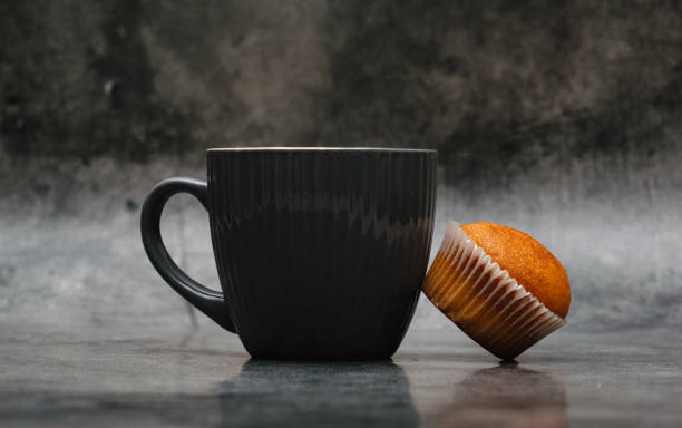 istock A cup of coffee and a cupcake next to it. 1409096710