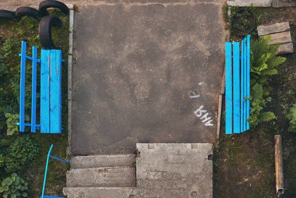 istock Blue benches standing against each other. Concrete steps. Adjacent territory, city yard. Holiday place near the house 1409097241