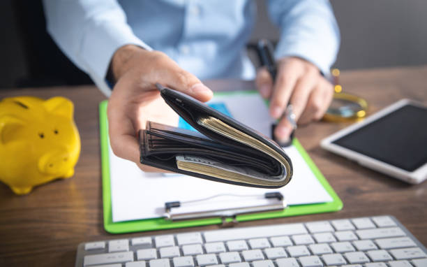 istock Businessman holding dollars with wallet. 1409100099