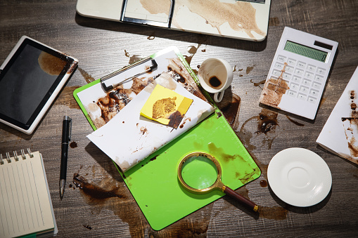 Coffee spilled over document and business objects.