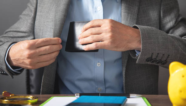 businessman pulls his leather wallet into suit pocket. - 13520 imagens e fotografias de stock