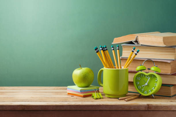 istock Student desk with books, apple and pencils. Back to school background 1409100165