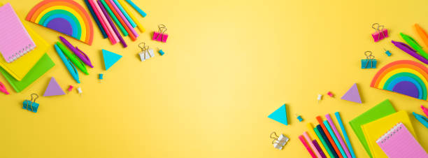 istock Back to school concept with notebooks, pens and rainbow sticky notes on yellow background. Top view, flat lay 1409100195