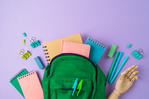 Creative top view composition with backpack and school supplies. Back to school  background. Flat lay