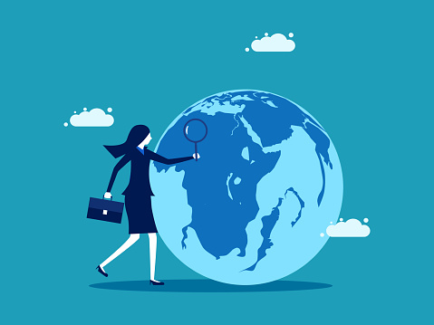 businesswoman uses a magnifying glass to look at the globe. business concept vector