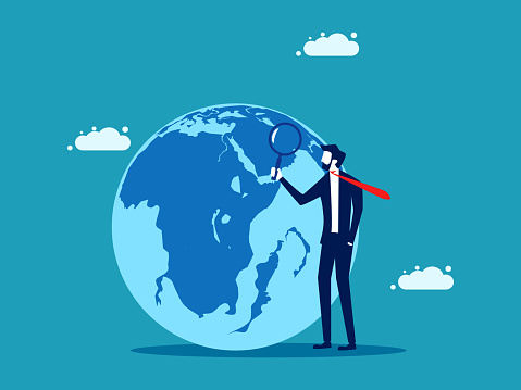 businessman uses a magnifying glass to look at the globe. business concept vector