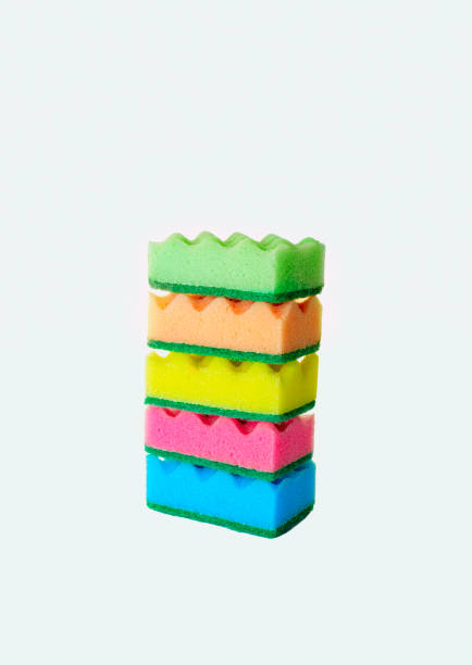istock Stack of colorful kitchen cleaning sponges with soap bubbles on white background. 1409114763