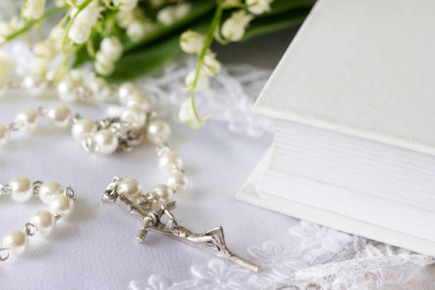 First Holy Communion with rosary and flowers, concept background religion
