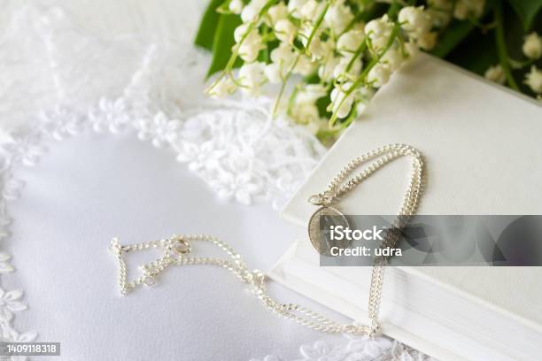 First Holy Communion With Sacred Medal On Chain And Flowers Concept Background Stock Photo - Download Image Now