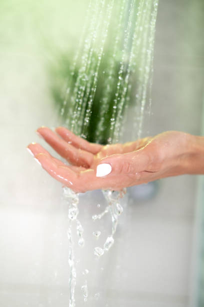 istock Close up female hand in the shower. 1409122645